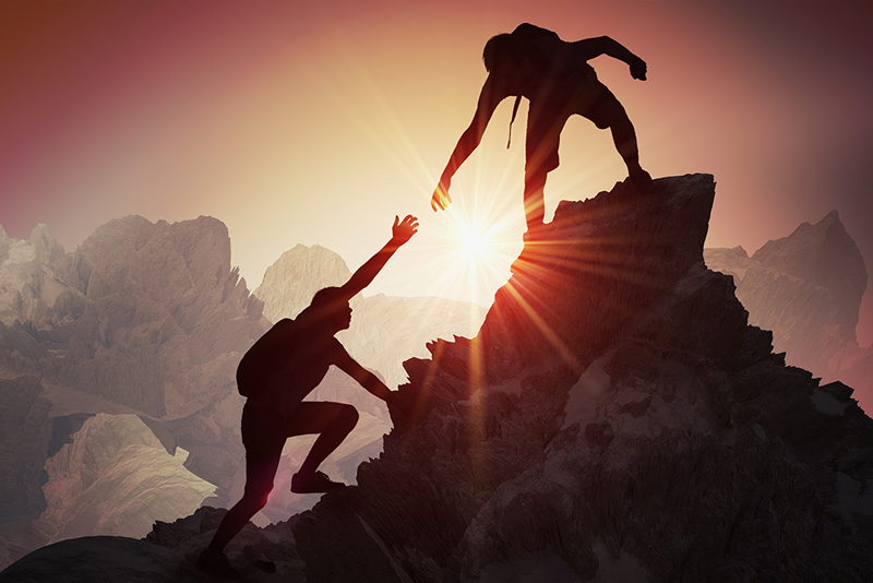 People climbing mountain peak